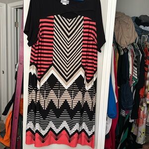 Geometric pattern with orange black gray and tan.small opening on the front.